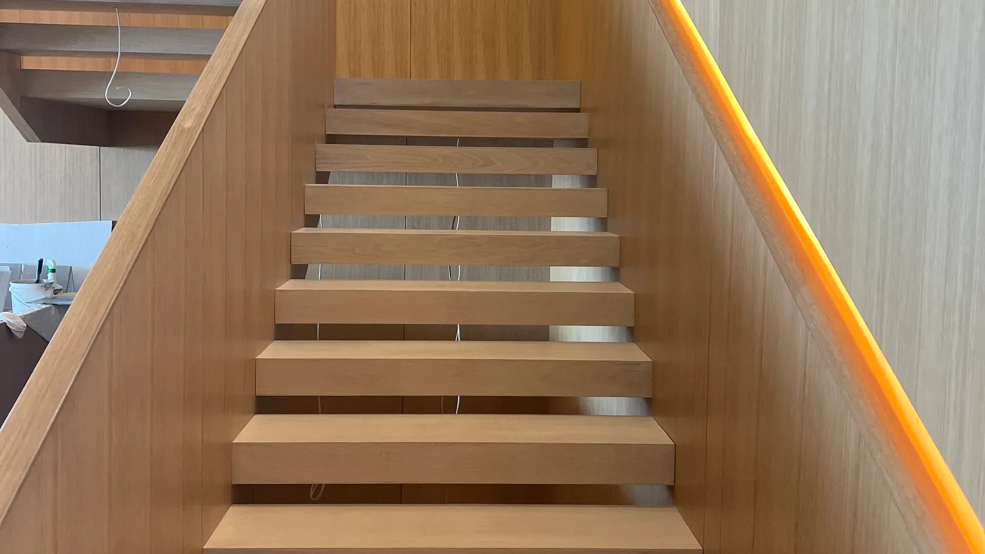 Floating hardwood staircase with integrated lighting built by WP High Quality Carpentry Corp