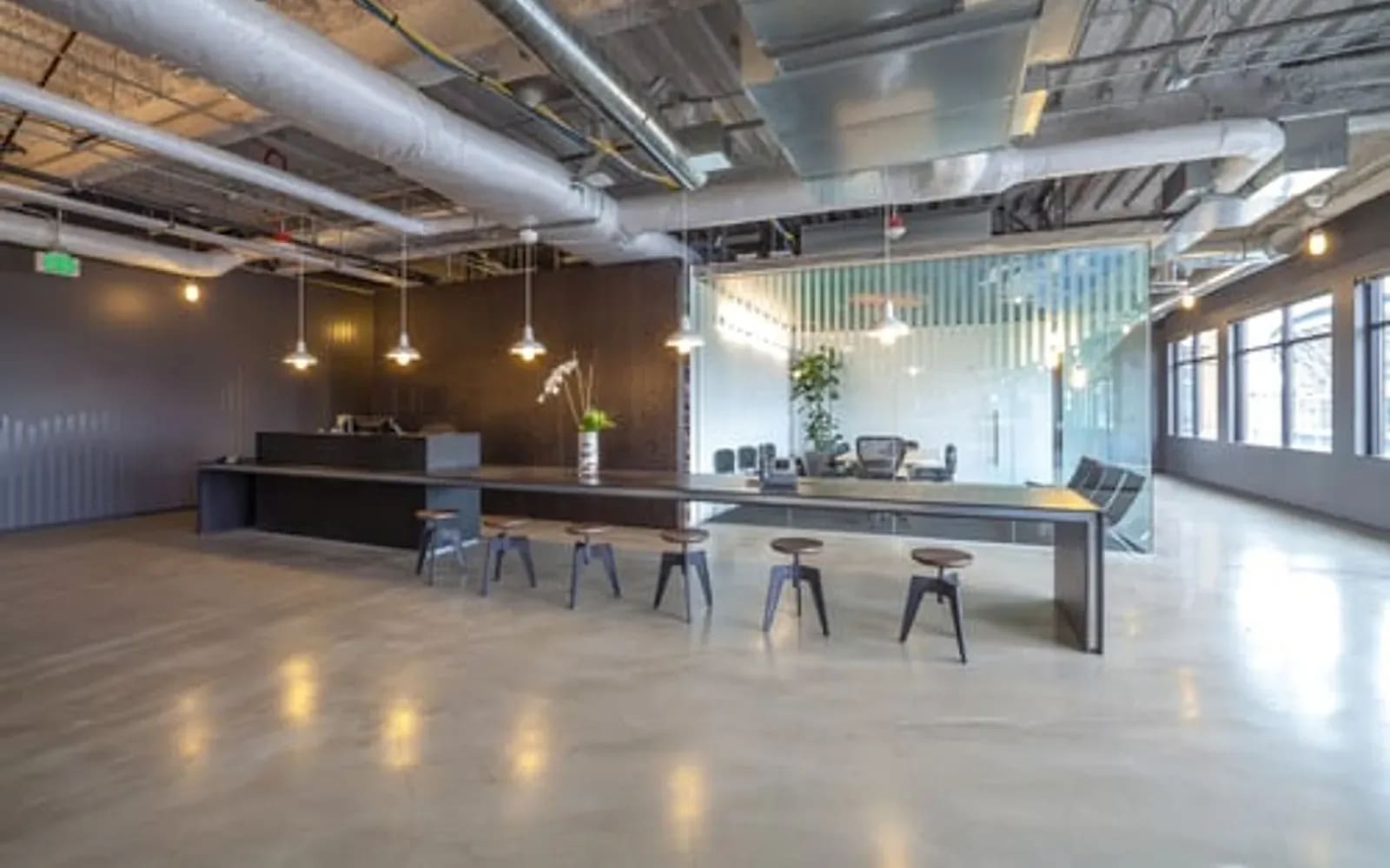 Modern commercial interior build-out with custom wood millwork bar and pendant lighting