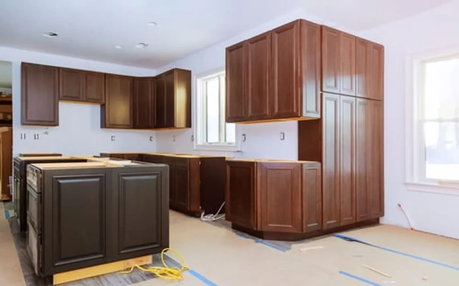 Custom stained wood kitchen cabinetry and island installed in a Hampton Bays home