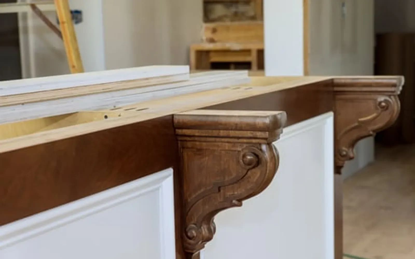 Carved wood corbel and painted trim detail installed by a finish carpenter