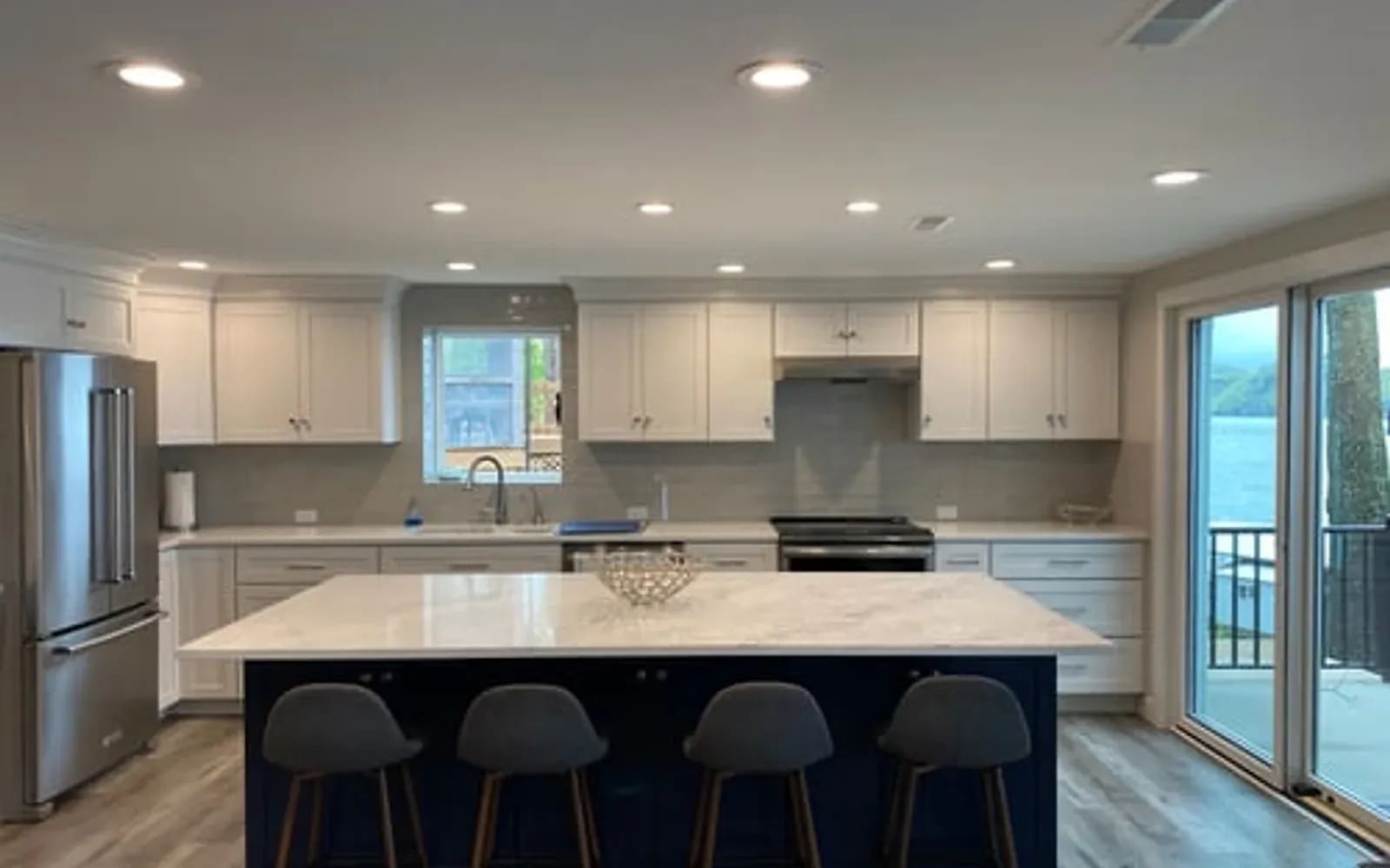 Bright remodeled luxury kitchen with large island, bar seating and custom cabinetry