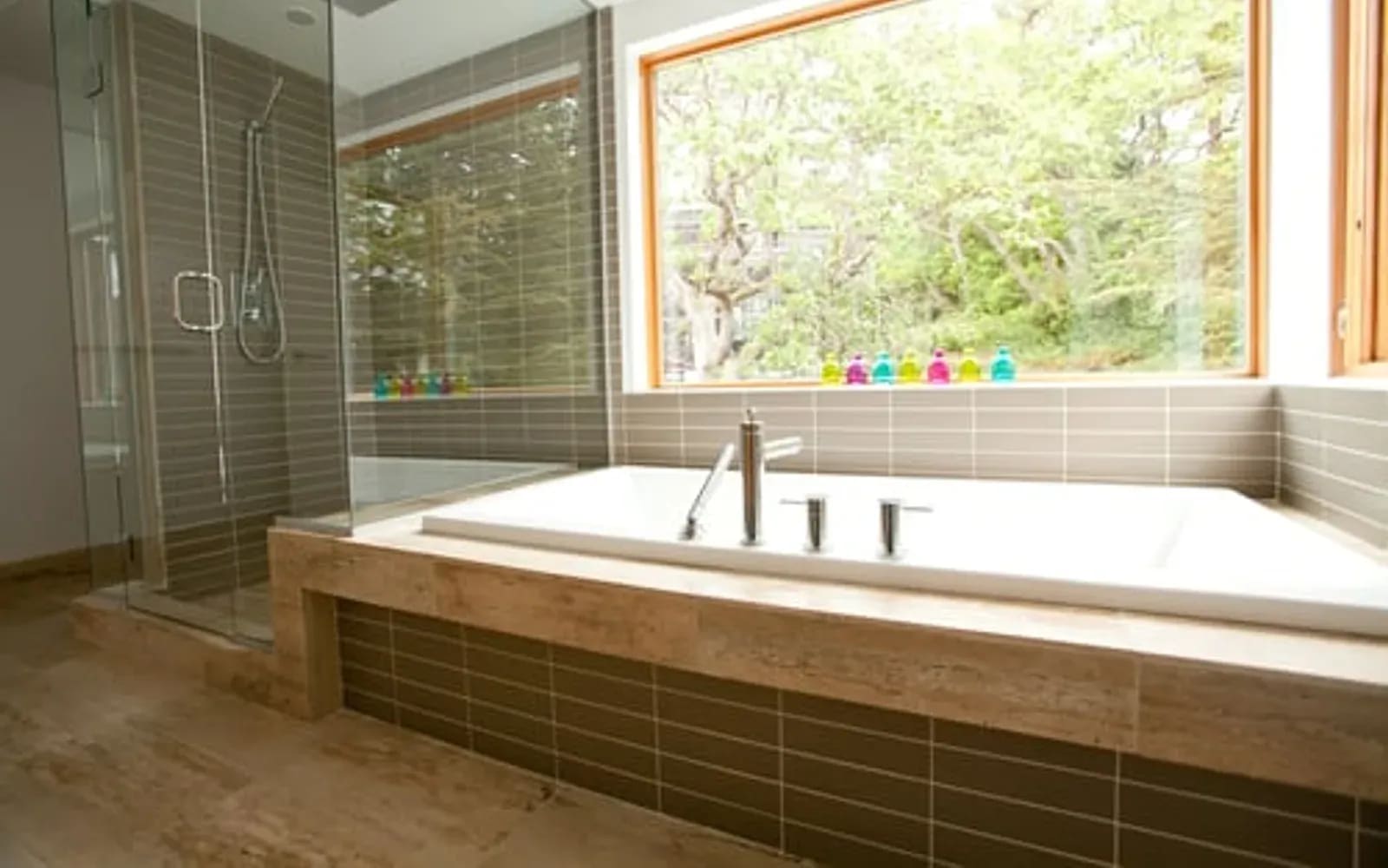 Spa bathroom renovation with wood-clad soaking tub deck and large picture window